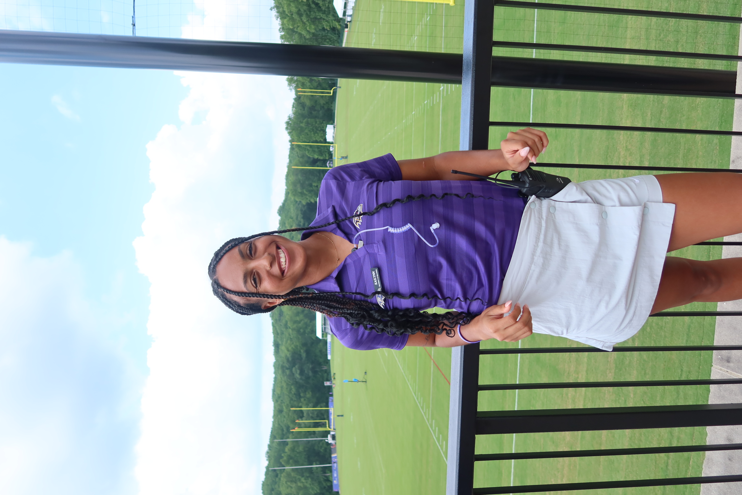 Jackson posing and smiling above football fields at the Baltimore Ravens practice facility.